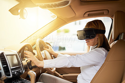 Buy stock photo Shot of a young businesswoman wearing a virtual reality headset while driving her car