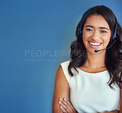 Buy stock photo Studio portrait of a confident young businesswoman posing against a blue background