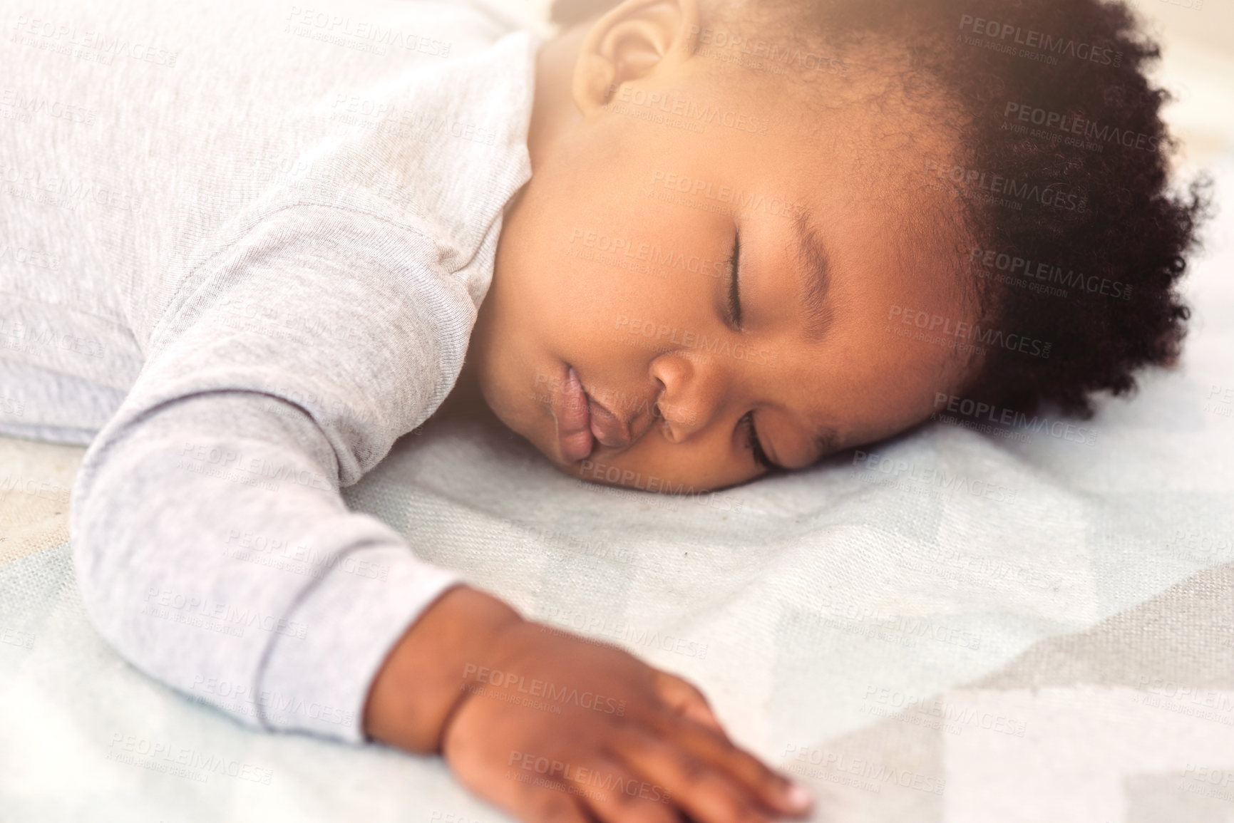 Buy stock photo Baby, african and boy sleeping on bed for rest, health and peace for growth, development and relax in family home. Black male infant, tired and sleep in bedroom with fatigue, quiet and calm in house