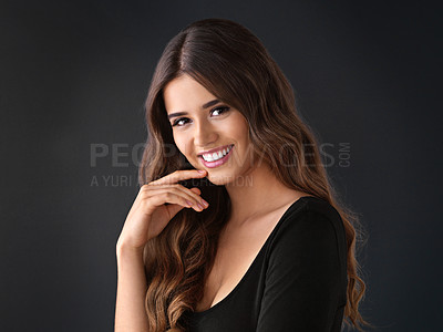 Buy stock photo Studio shot of a beautiful young woman against a dark background