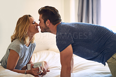 Buy stock photo Shot of a couple rubbing their noses together in the bedroom at home