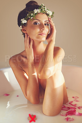 Buy stock photo Portrait of a beautiful nude woman relaxing in a bathtub filled with milk and flower petals at home