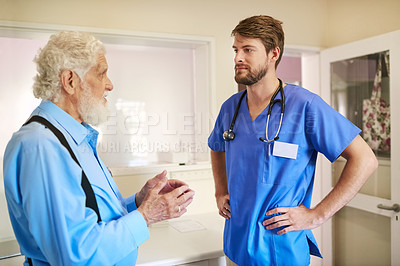 Buy stock photo Shot of a senior patient consulting with his doctor in the hospital