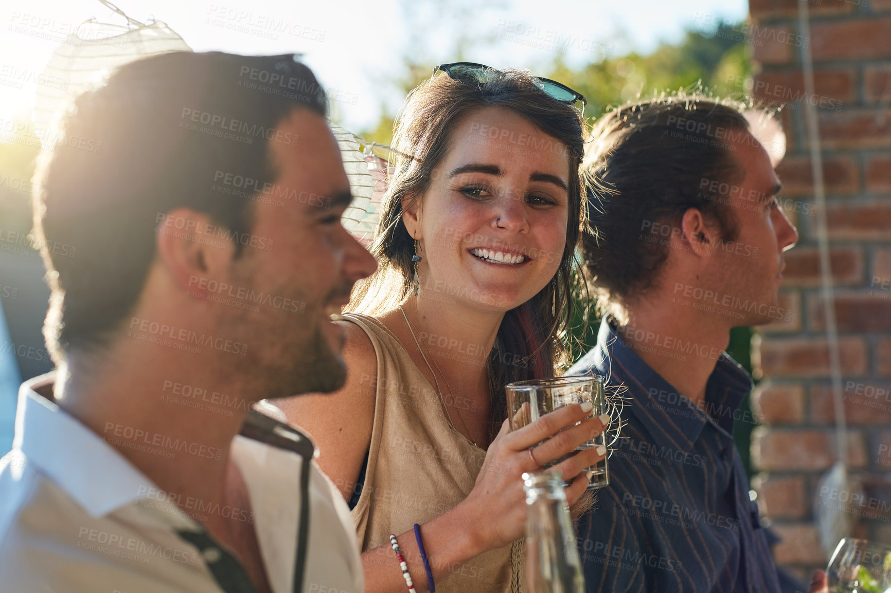 Buy stock photo Friends, drink and happy in backyard, party and excited with relax, summer and celebration. People, men and woman with conversation, wine and social group at event with smile on holiday in Ireland