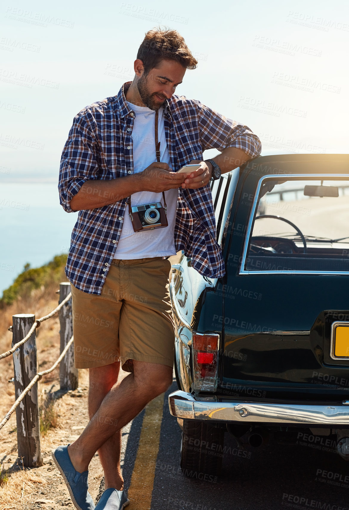 Buy stock photo Man, road trip and online with smartphone by car for navigation app, checking route and directions for journey. Person, happy and camera for travel documentation, adventure and internet for research.