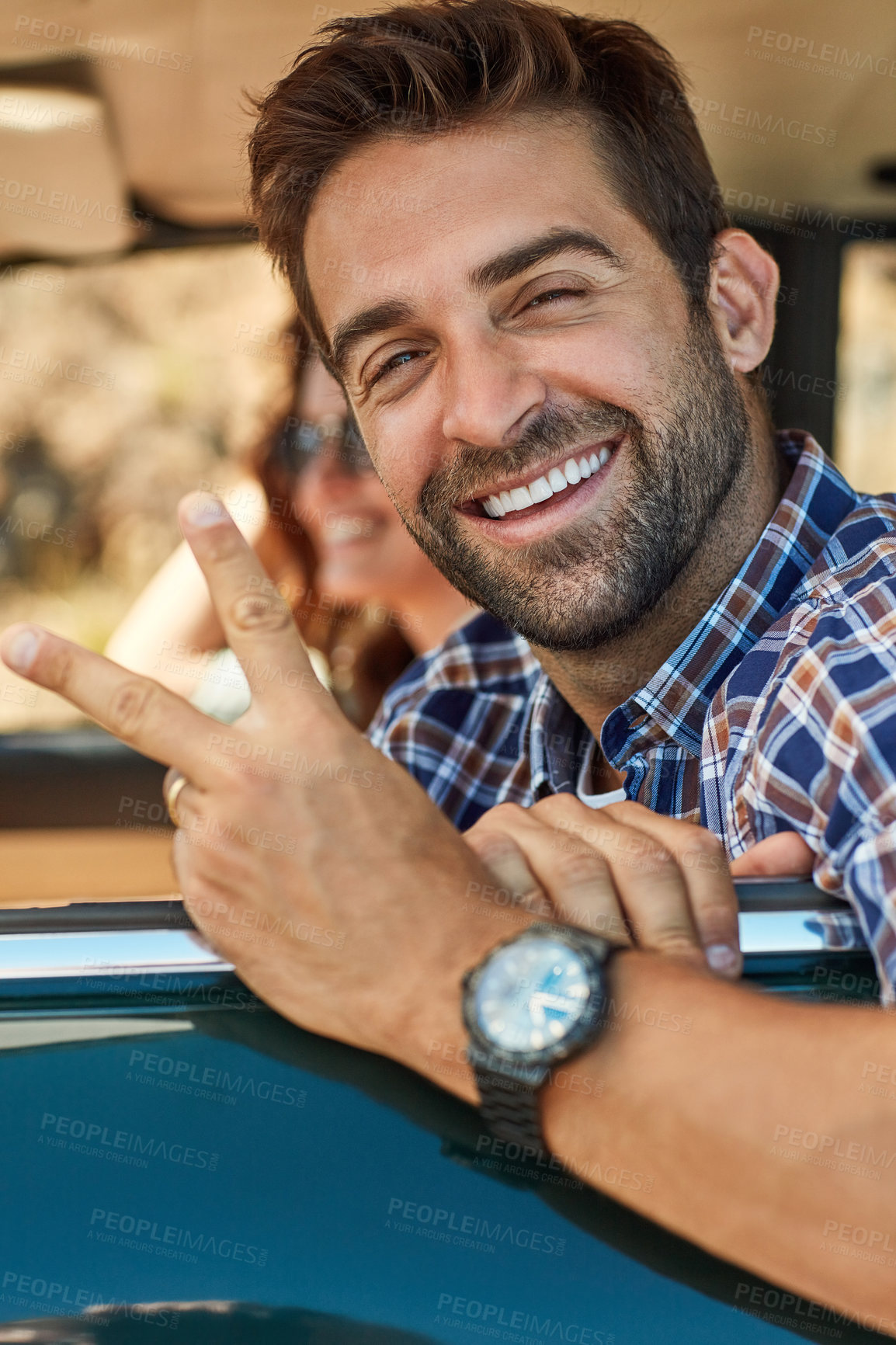 Buy stock photo Cropped portrait of a handsome man giving you a peace sign while enjoying a roadtrip