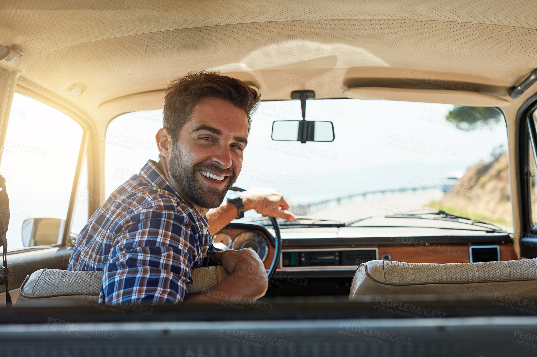 Buy stock photo Rearview portrait of a handsome man enjoying a summer roadtrip