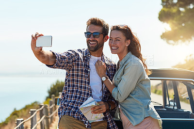 Buy stock photo Cropped shot of an affectionate couple taking a selfie while enjoying a roadtrip