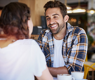 Buy stock photo Shot of a happy young couple spending time together in a coffee shop
