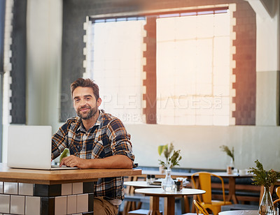 Buy stock photo Portrait of a happy young entrepreneur working on his laptop in a coffee shop