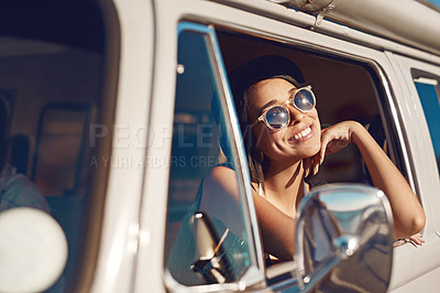 Buy stock photo Shot of a happy young woman daydreaming on a road trip