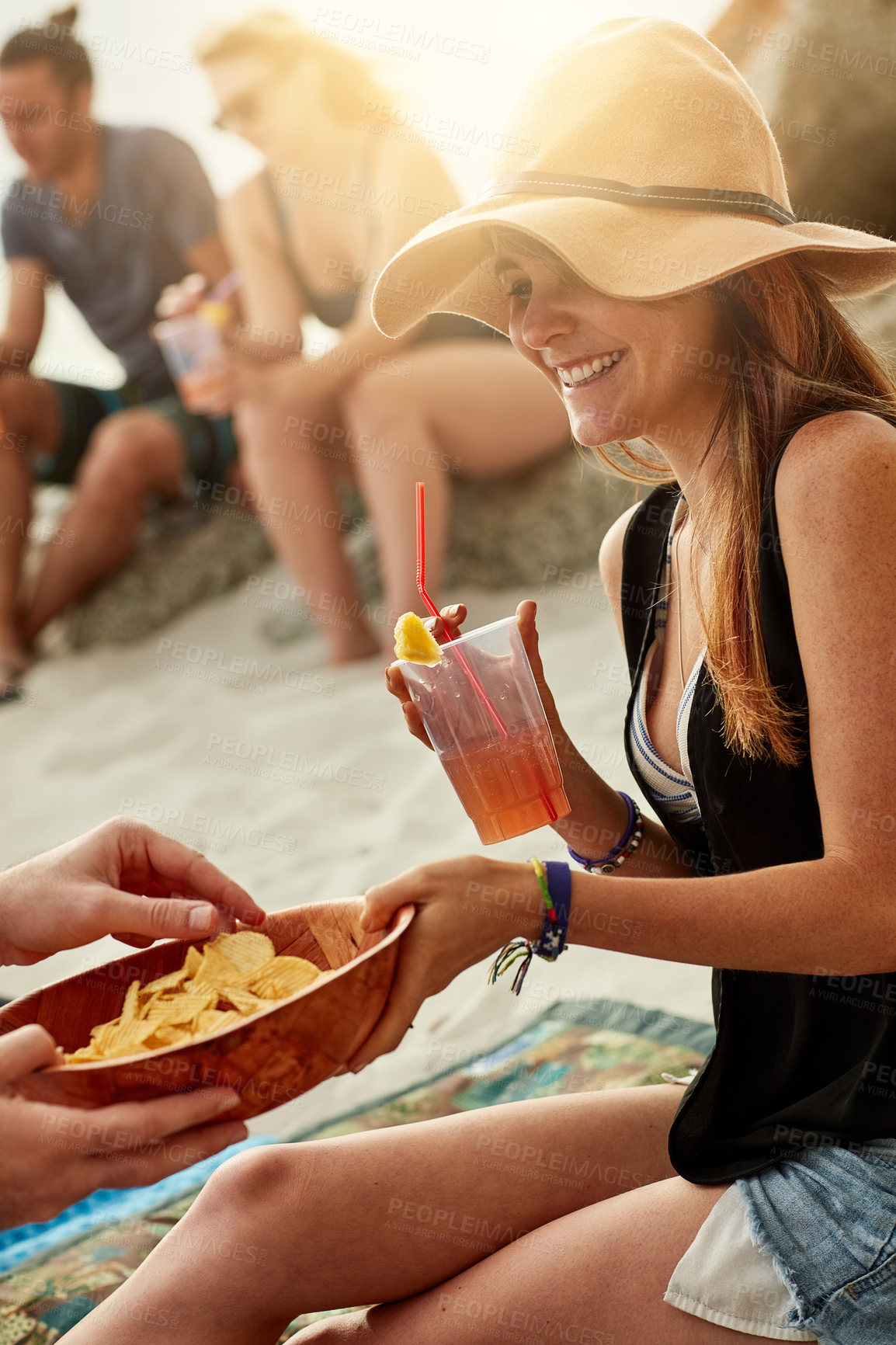 Buy stock photo Friends, woman and juice on beach for picnic, relaxing and enjoy on summer vacation in California. Outdoor, people and female person with happiness for snack, chips and beverage for drinking by sand