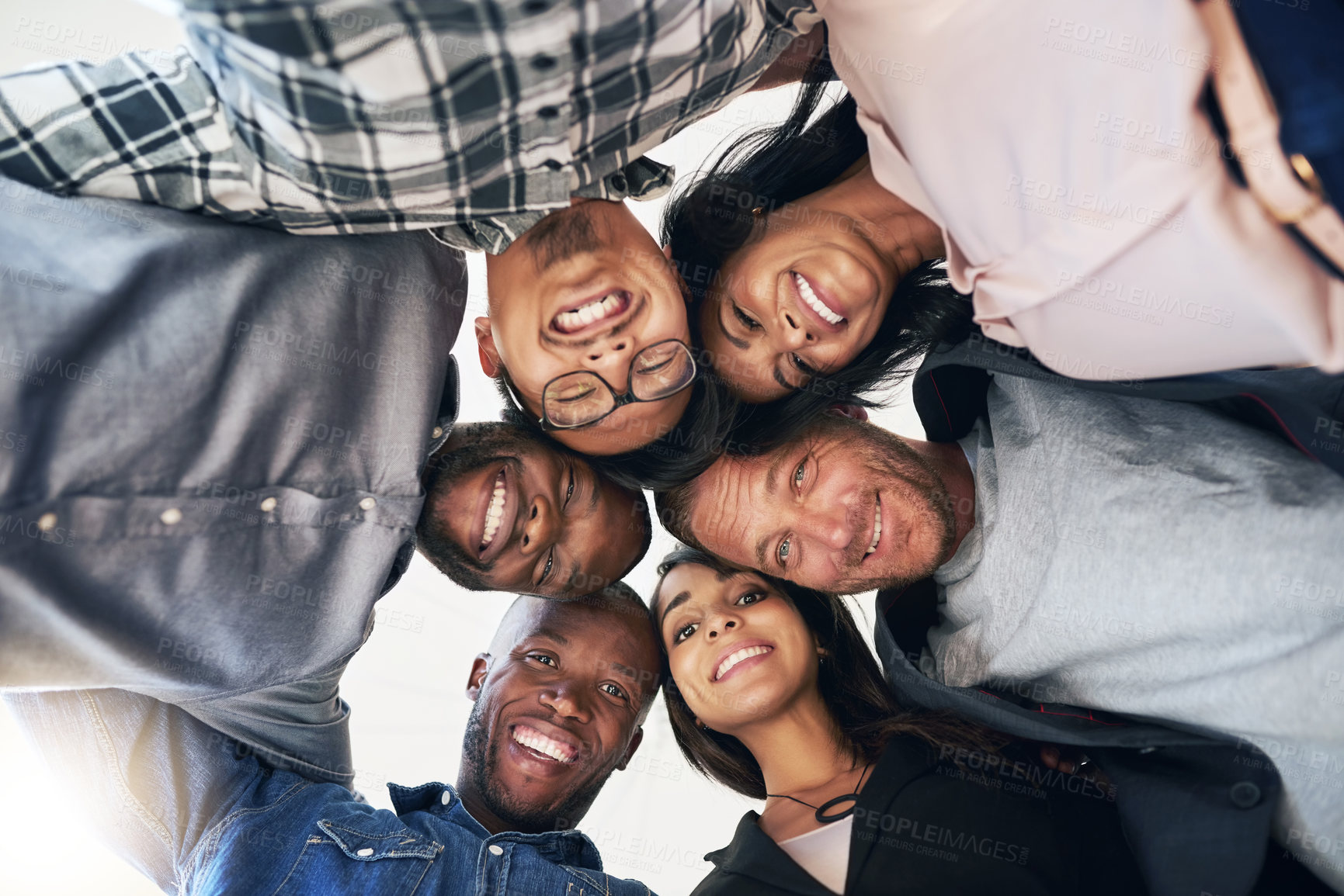 Buy stock photo Business people, head and circle together in office for motivation or achievement, synergy and group effort for task success. Low angle, huddle and teamwork with support, diversity and collaboration.