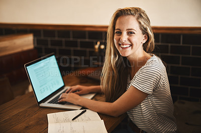 Buy stock photo Portrait of a happy young student using her laptop to study at a cafe table