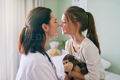 Buy stock photo Shot of a friendly doctor sitting in front of her young patient