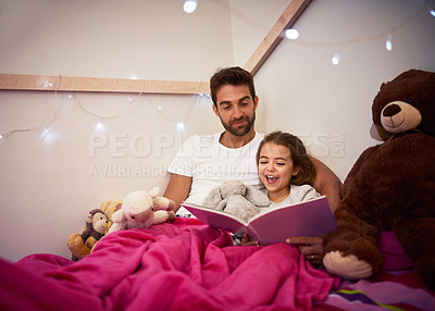 Buy stock photo Cropped shot of a father reading a book with his little daughter in bed at home