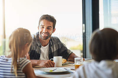 Buy stock photo Shot of a father having breakfast with his children at home