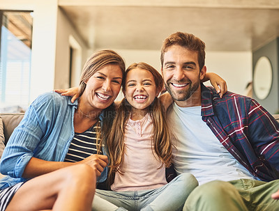 Buy stock photo Shot of a happy family of three relaxing together on the sofa at home
