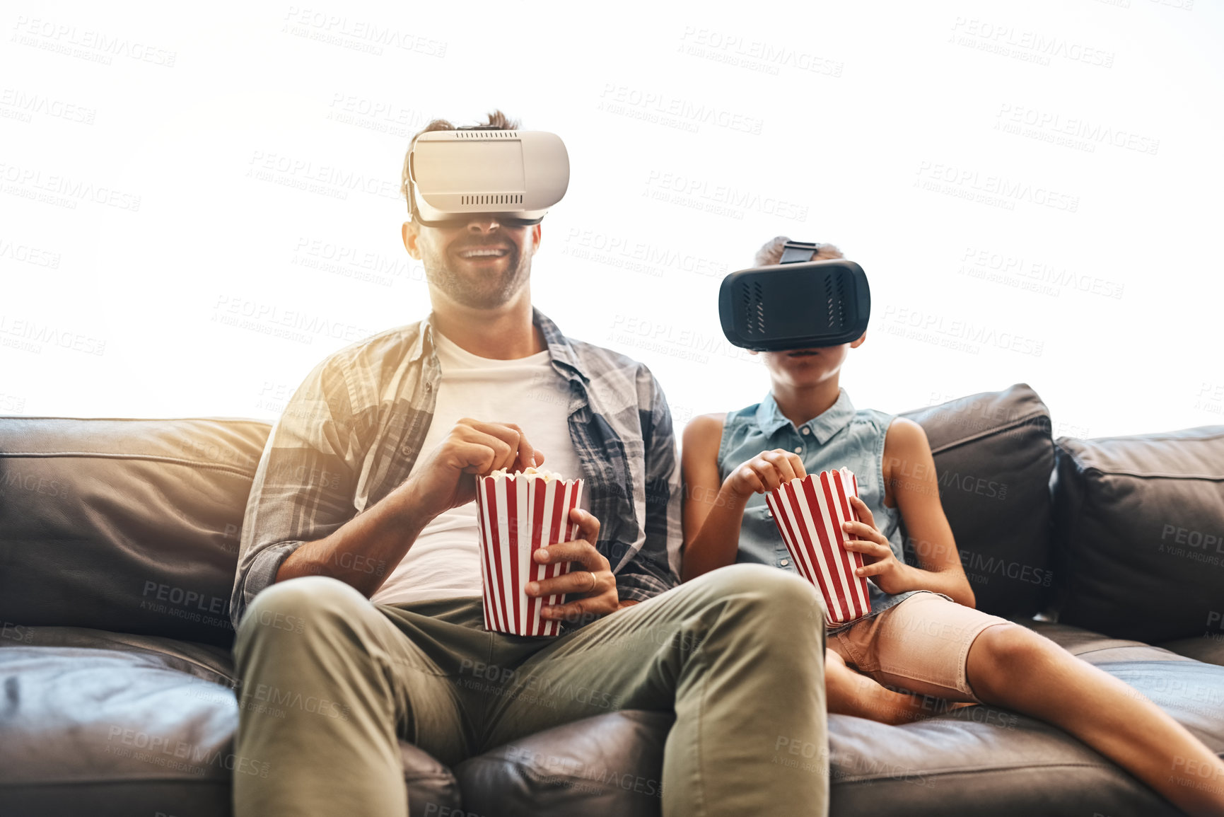 Buy stock photo VR, father and girl on sofa with popcorn for futuristic, streaming movies or entertainment in living room. Lens flare, metaverse and young child for simulation, augmented reality or film in home