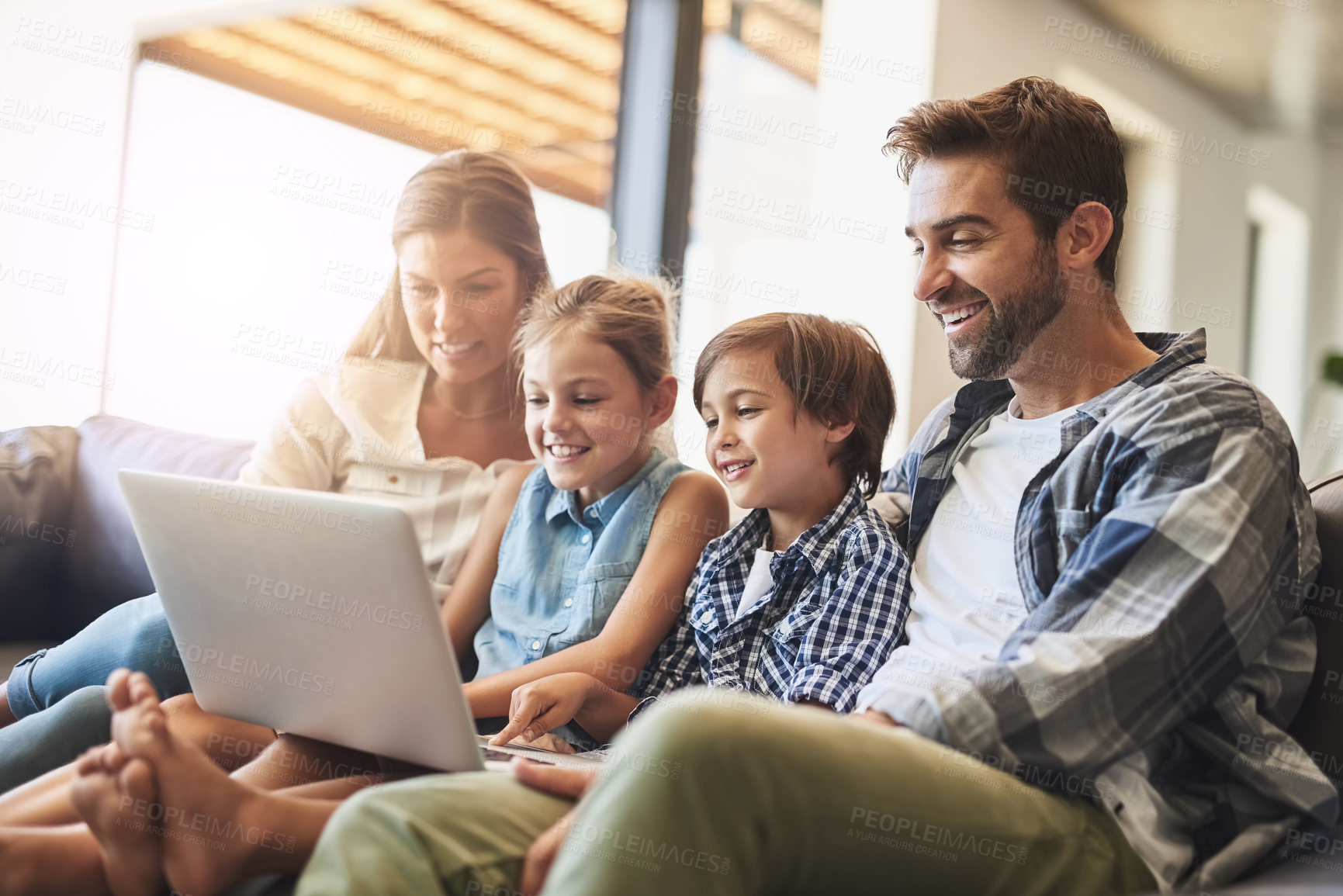 Buy stock photo Family, laptop and kids smile with parents on a living room sofa with education game online. Mom, dad and young children together with bonding, care and love in a house streaming a video on computer