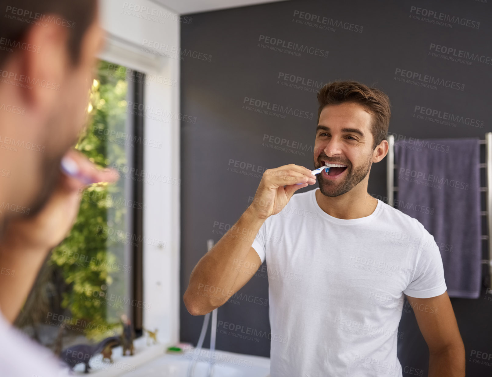 Buy stock photo Man, smile and brushing teeth in mirror of bathroom for oral hygiene, fresh breath and morning routine in home. Happy person, reflection or cleaning mouth for dental health, self care or healthy gums