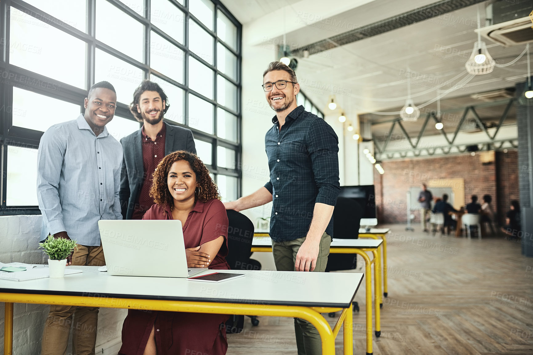 Buy stock photo Cropped portrait of a group of businesspeople standing around a desk in their office