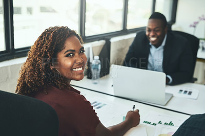 Buy stock photo High angle portrait of a young businesswoman working across from a male colleague in the office