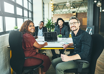 Buy stock photo Cropped portrait of a group of colleagues working around a desk in their office
