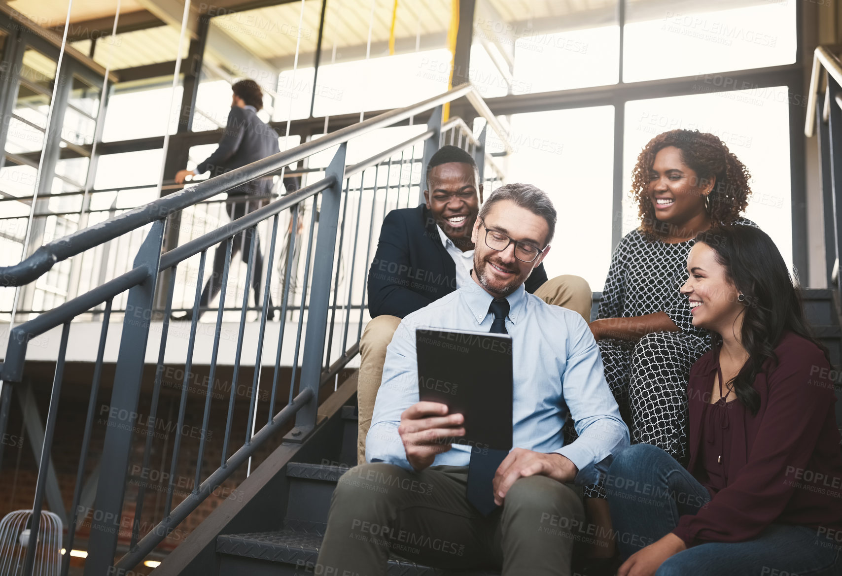 Buy stock photo Tablet, team and business people in discussion, laughing or  planning project on stairs. Tech, diversity or group of happy workers with sales manager for funny meme, joke or comedy at startup meeting