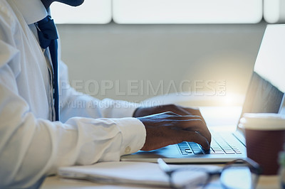 Buy stock photo Shot of an unrecognisable businessman working on a laptop in an office