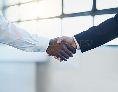 Buy stock photo Shot of two unrecognisable businessmen shaking hands in an office