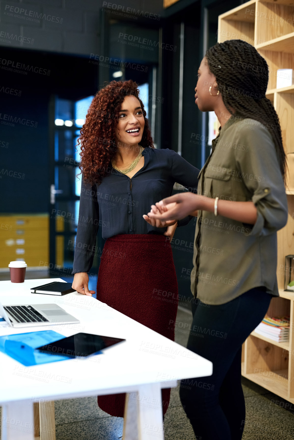 Buy stock photo Shot of two businesswomen having a discussion in an modern office