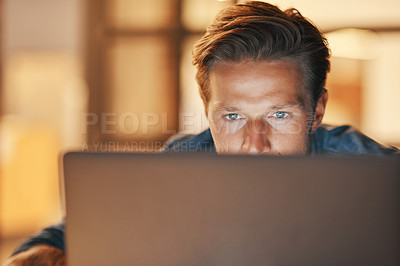 Buy stock photo Shot of a handsome young man working late in his office