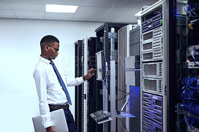 Buy stock photo Cropped shot of a IT technician working and checking if all the servers are up and running