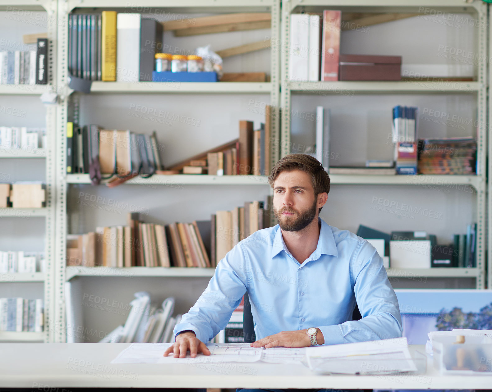 Buy stock photo Cropped shot of a handsome young male architect sitting in his office