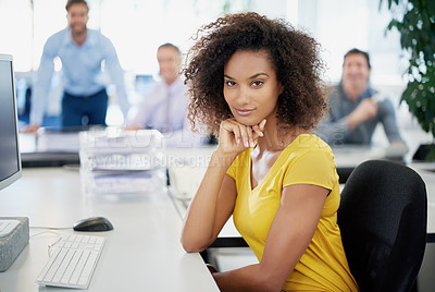 Buy stock photo Portrait of an attractive young businesswoman sitting in an office with her colleagues in the background