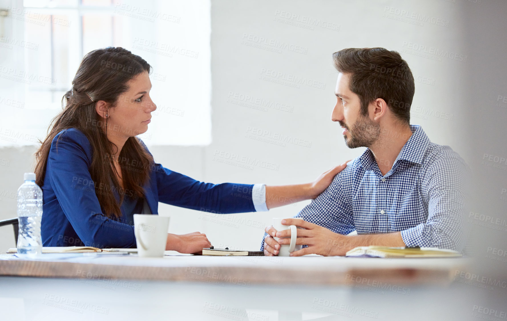 Buy stock photo Cropped shot of an attractive young businesswoman reassuring a male colleague in the office