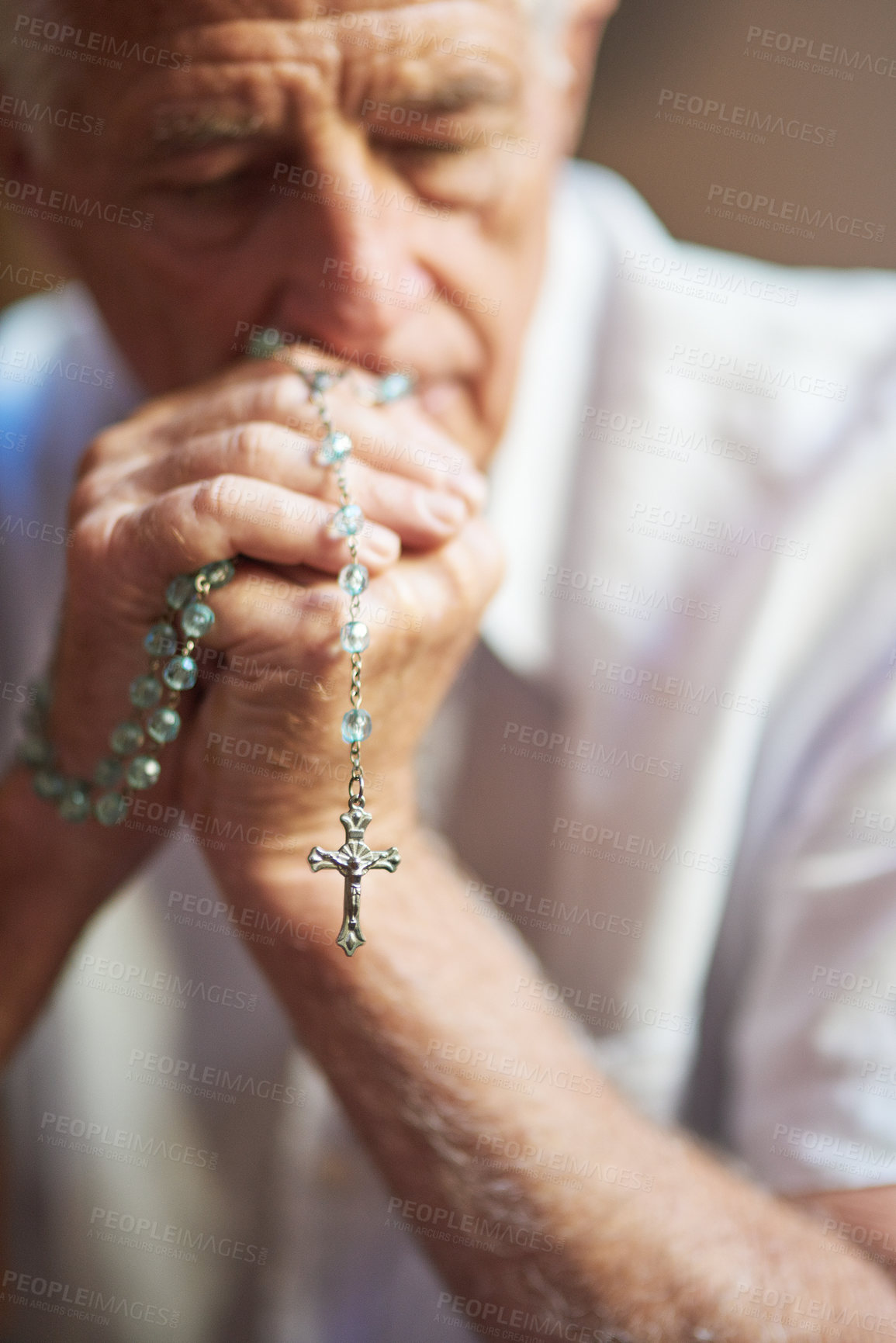 Buy stock photo Cropped shot of a senior man holding a rosary while praying for a miracle