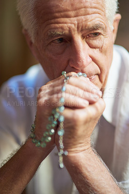 Buy stock photo Christian, rosary and elderly man with thinking in prayer for spiritual healing, support and worship to God. Retirement, home and person with crucifix for faith, religion and praise to Holy Spirit