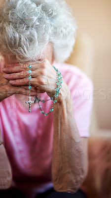 Buy stock photo Cropped shot of a senior woman holding a rosary while praying for a miracle
