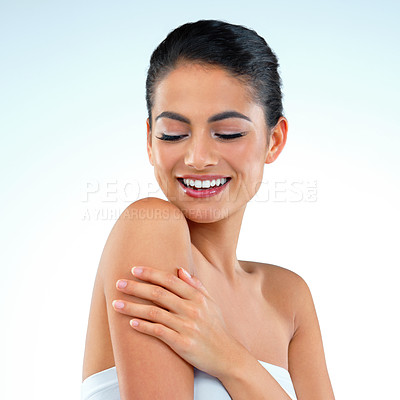 Buy stock photo Studio shot of a beautiful young woman posing against a blue background