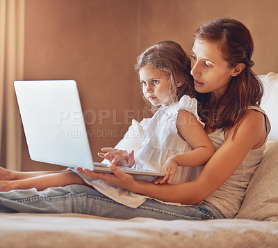 Buy stock photo Mom, girl and laptop in home for streaming movies, bonding and relationship together on bed. Woman, child and technology in apartment for tv show, cartoon or social media with relax and subscription