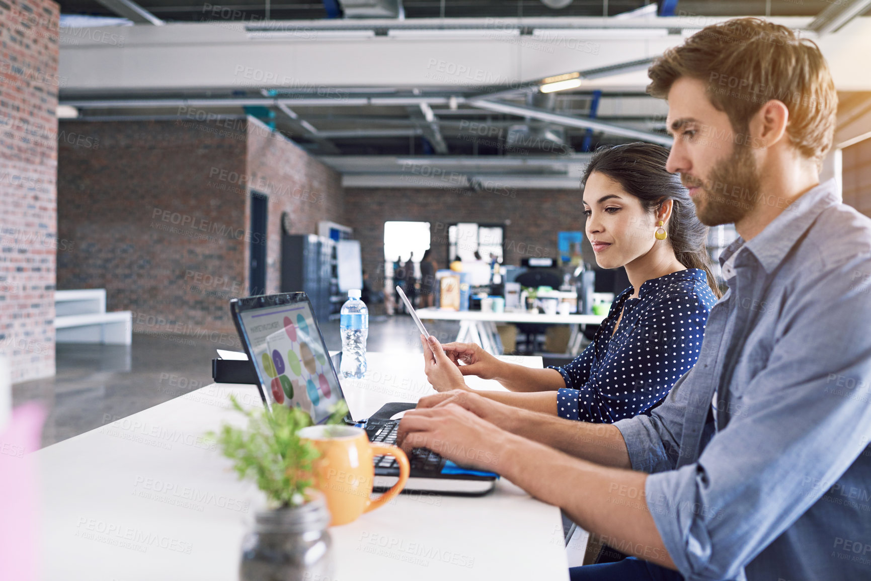 Buy stock photo Teamwork, office and laptop, man and woman at desk with laptop at creative agency, working on project together. Leadership, partnership and happy employees or business partner at design startup.