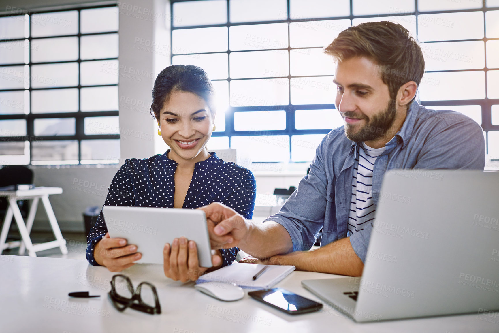 Buy stock photo Internet, tablet and woman with man in office sharing idea or meme at meeting for creative project. Teamwork, social media and employees in startup discussion at design agency for content marketing.