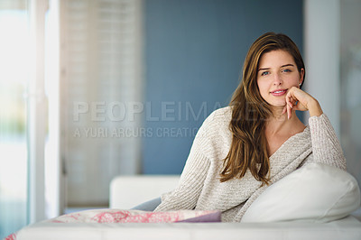 Buy stock photo Portrait of a happy young woman relaxing on the couch at home