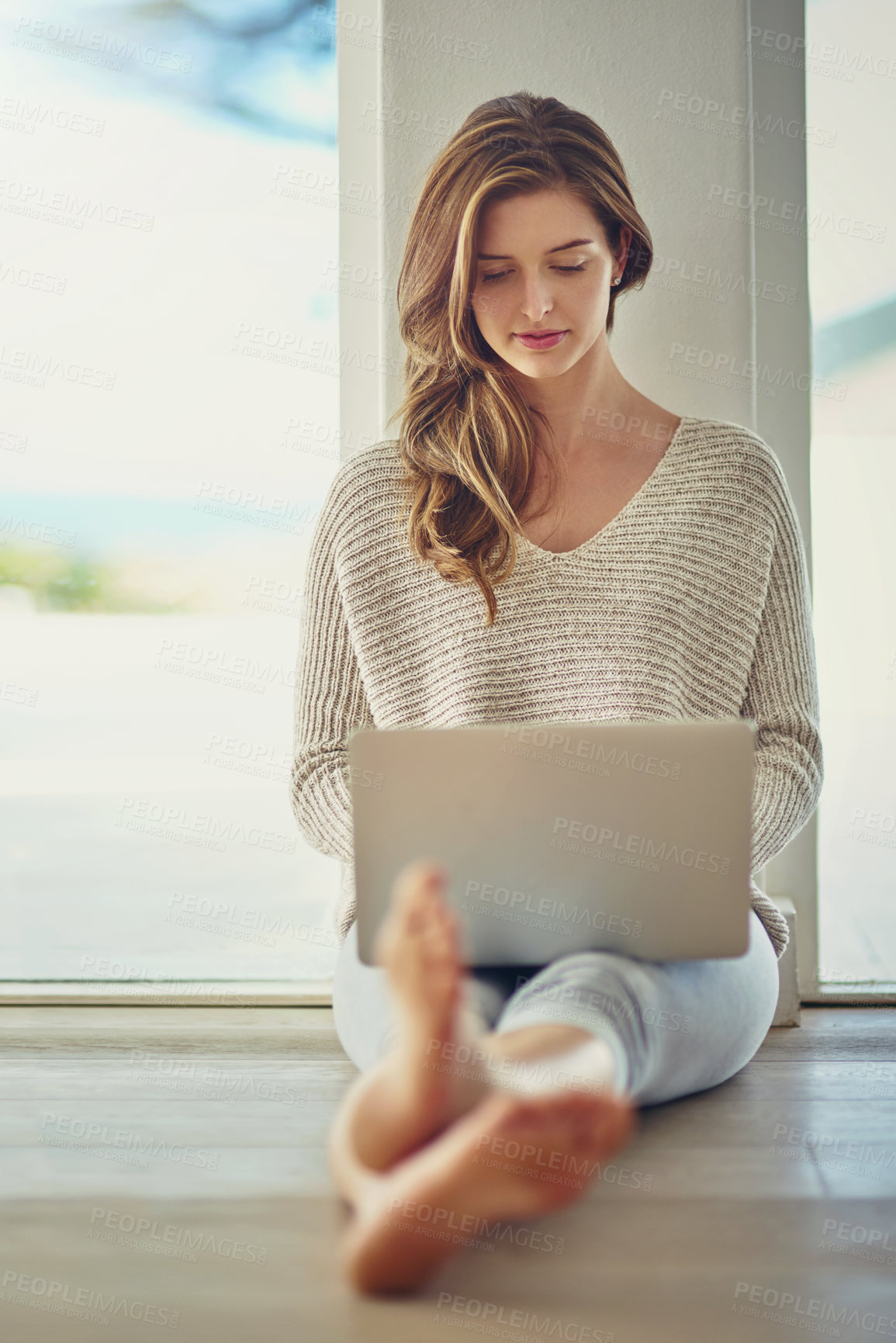 Buy stock photo Relax, laptop and woman on floor in home for streaming subscription, watching movies and internet. Lens flare, apartment and person on computer for website, networking and research in living room