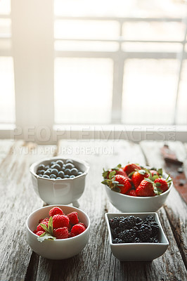 Buy stock photo Bowls, berries and breakfast on table, kitchen and organic choice for nutrition, health and salad for wellness. Fruits, raspberry and mulberry in home with container, meal prep and food in morning