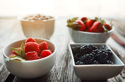 Buy stock photo Bowls, berries and breakfast on table, home and organic choice for nutrition, health and salad for wellness. Fruits, strawberry and mulberry in kitchen with container, meal prep and food in morning