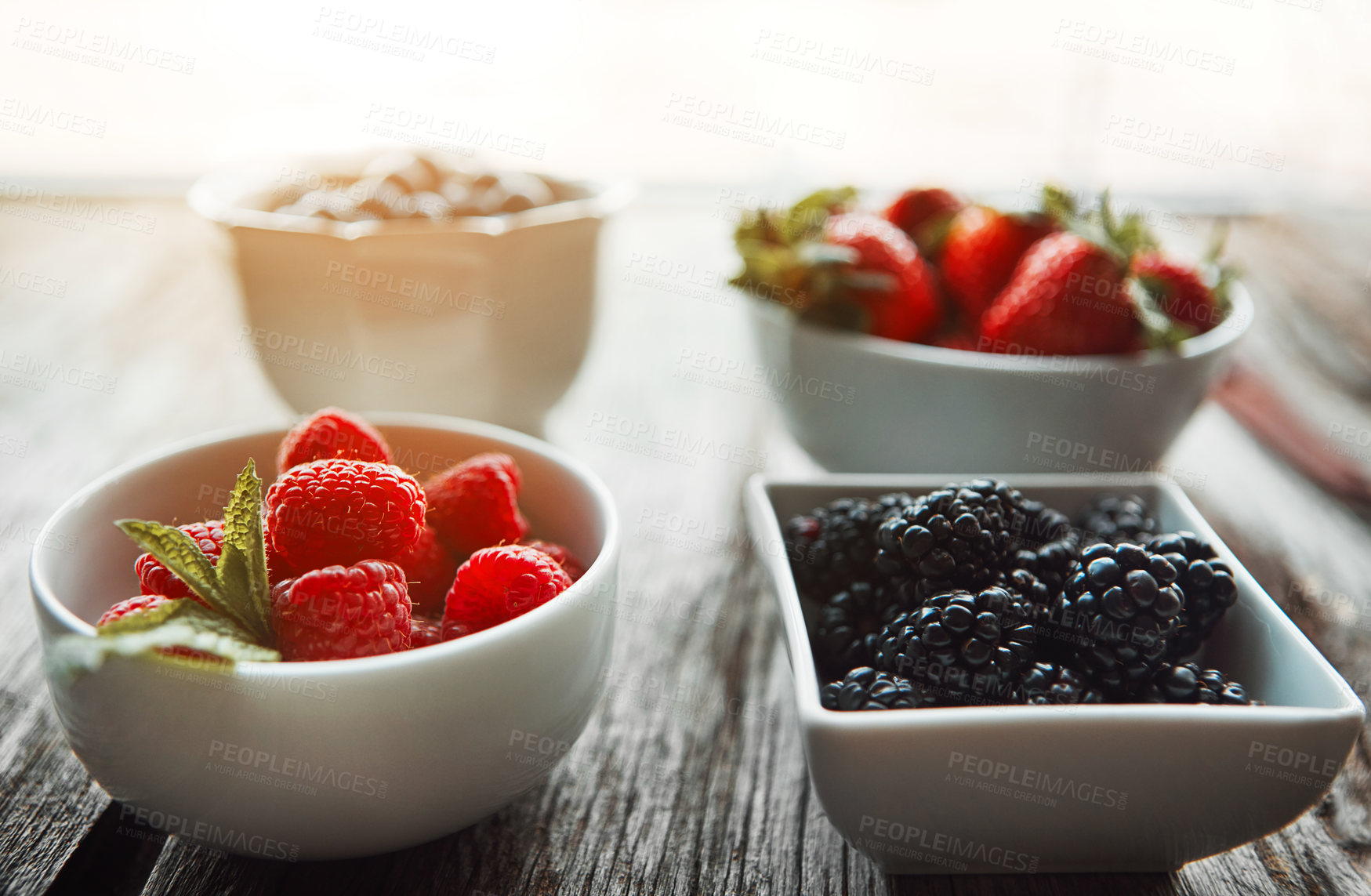 Buy stock photo Bowls, berries and breakfast on table, home and organic choice for nutrition, health and salad for wellness. Fruits, strawberry and mulberry in kitchen with container, meal prep and food in morning