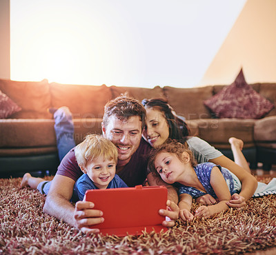 Buy stock photo Family, tablet and watching movies in lounge together, relax and streaming subscription for cartoon. Parents, children and online for series in home, love and entertainment for happiness bonding 